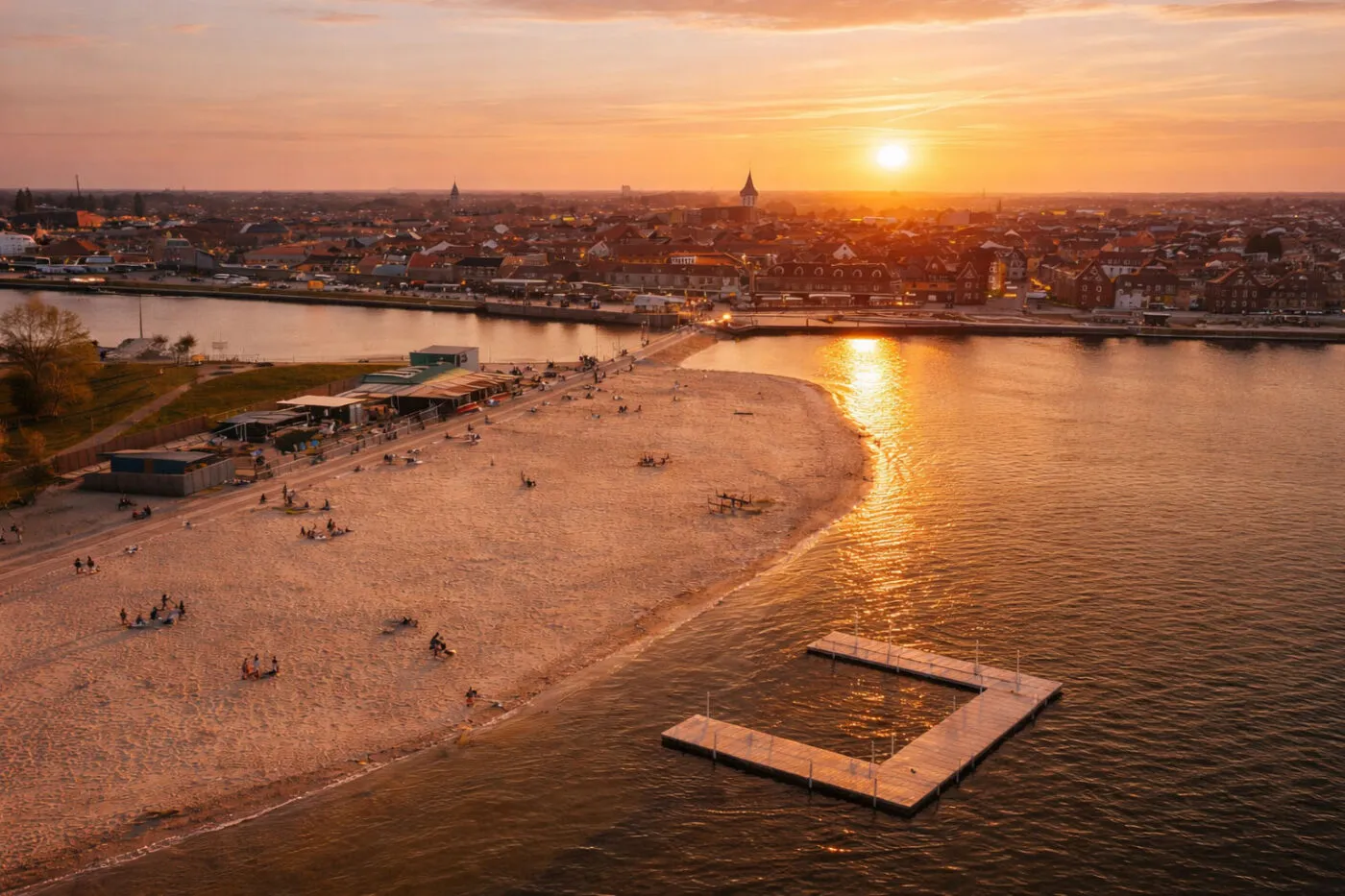 Strandeiland Harderwijk aan het Wolderwijd bij zonsondergang met uitzicht op de binnenstad